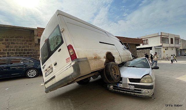 MİNİBUS, PARK HALİNDEKİ OTOMOBİLİN ÜSTÜNE ÇIKTI